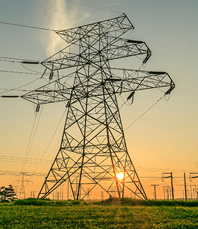 High-voltage transmission tower at sunset